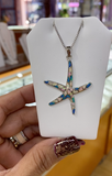 Hypoallergenic starfish pendant featuring real opal gemstones in shades of blue, pink, green, and white.