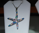 Hypoallergenic starfish pendant featuring real opal gemstones in shades of blue, pink, green, and white.